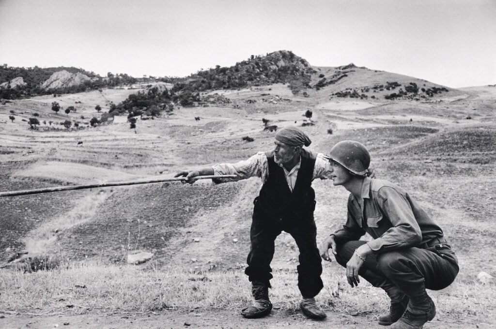 Robert Capa Sicilian peasant telling an American officer which way the Germans had gone. Near Troina. Italy. August, 1943. © Robert Capa © International Center of Photography | Magnum Photos