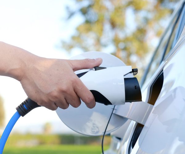 Electric car or ev is charging at station man use the white po