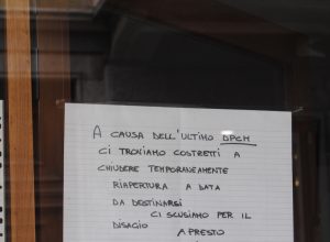 Un cartello affisso sulla vetrina di un ristorante in centro Aosta