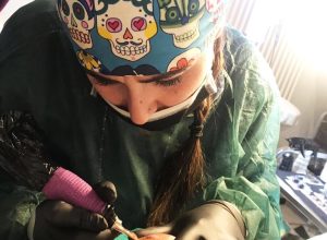 Chicca Pignataro al lavoro su un tatuaggio paramedicale